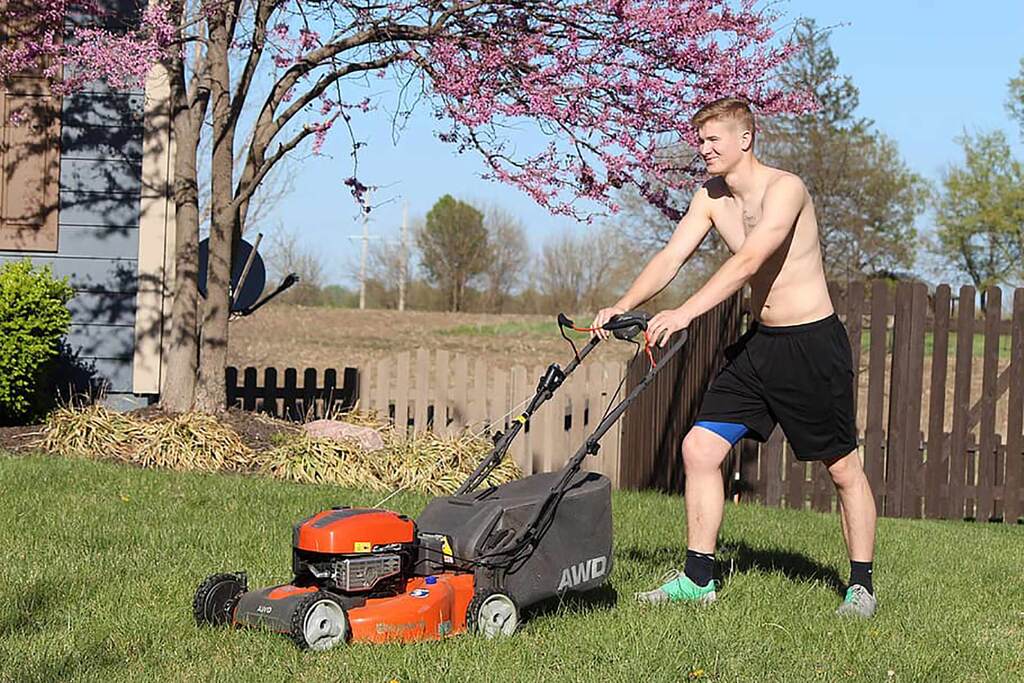 Teenager mowing without PPE